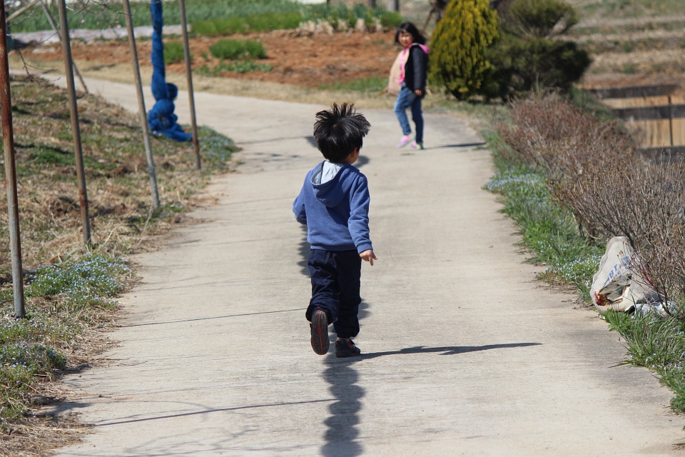 child running on pathway